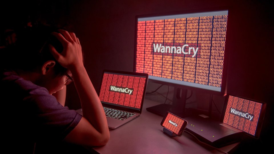 WannaCry ransomware attack on desktop screen, notebook and smartphone, cyber attack internet security concept