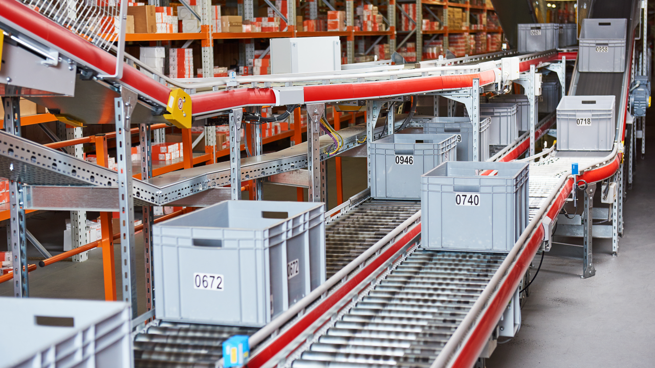 warehouse bins on conveyor belt at takeoff technology