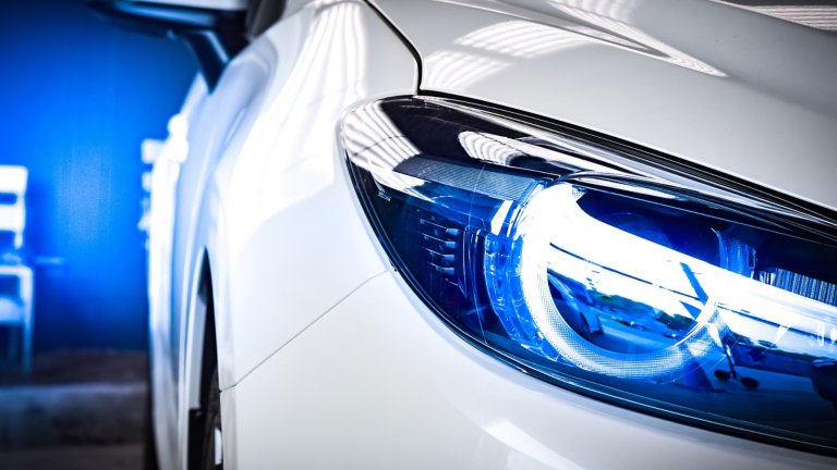 Close up of headlights on a white car