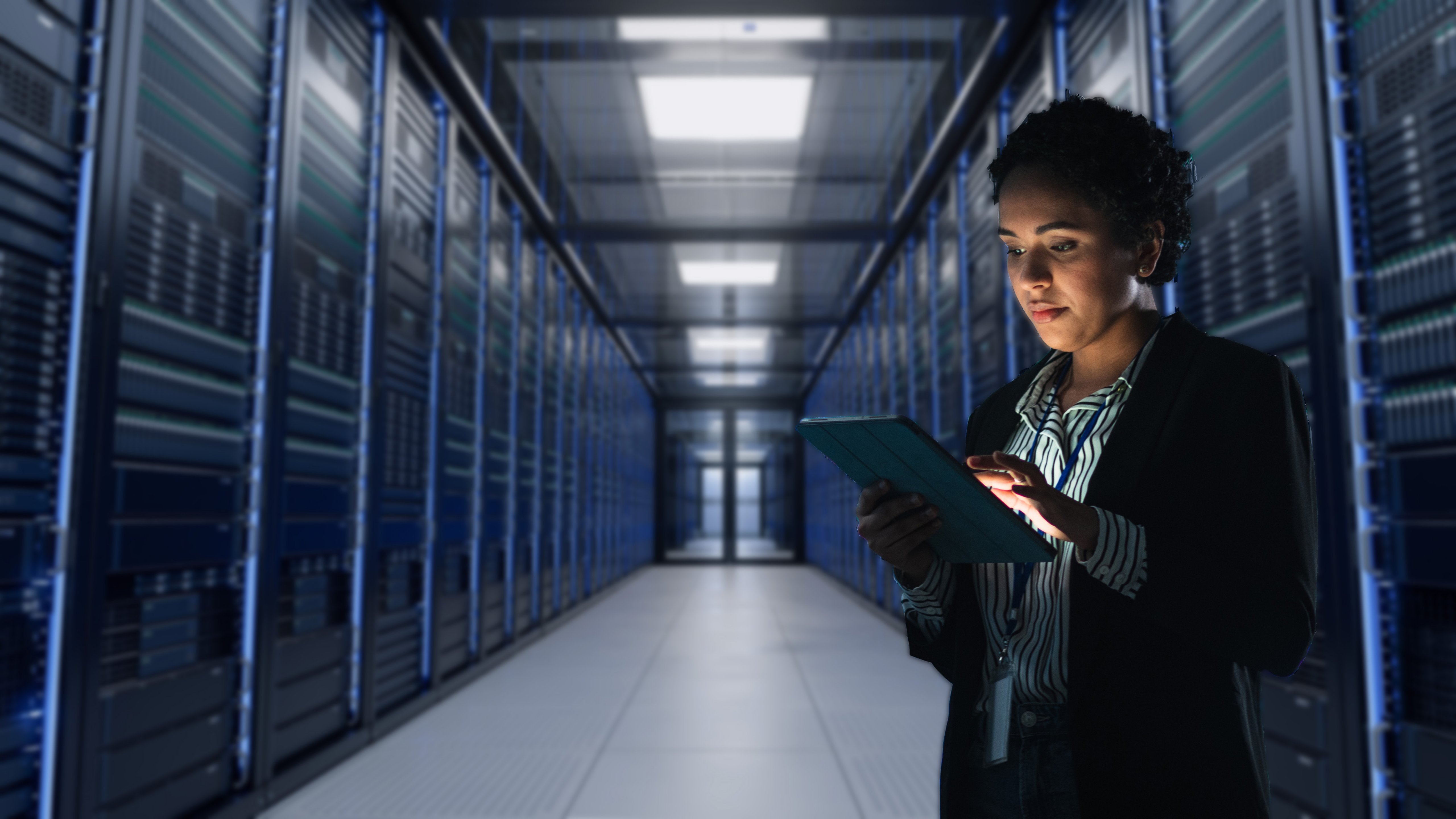 woman holding ipad in server room