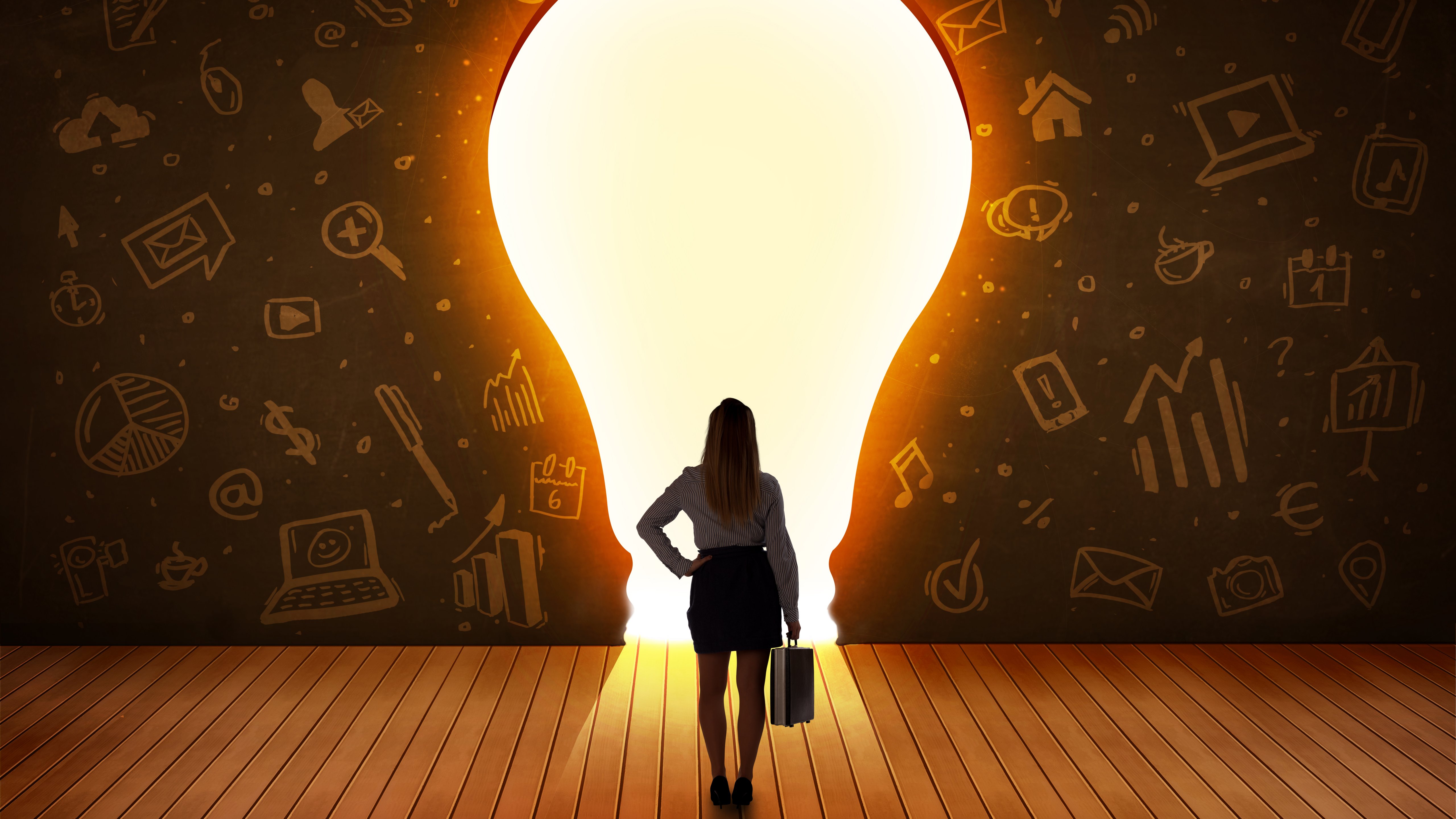 Woman standing in front of big lightbuld on the wall