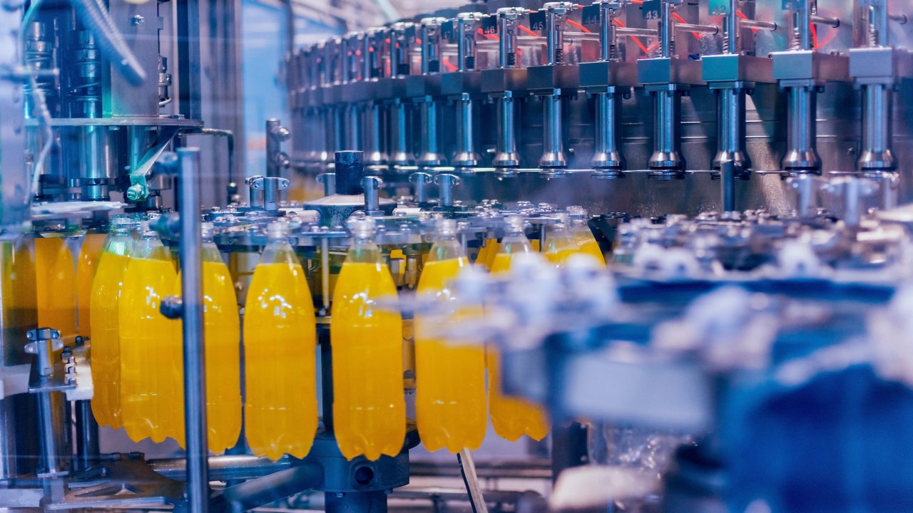 Food and Beverage Yellow bottles on assembly line