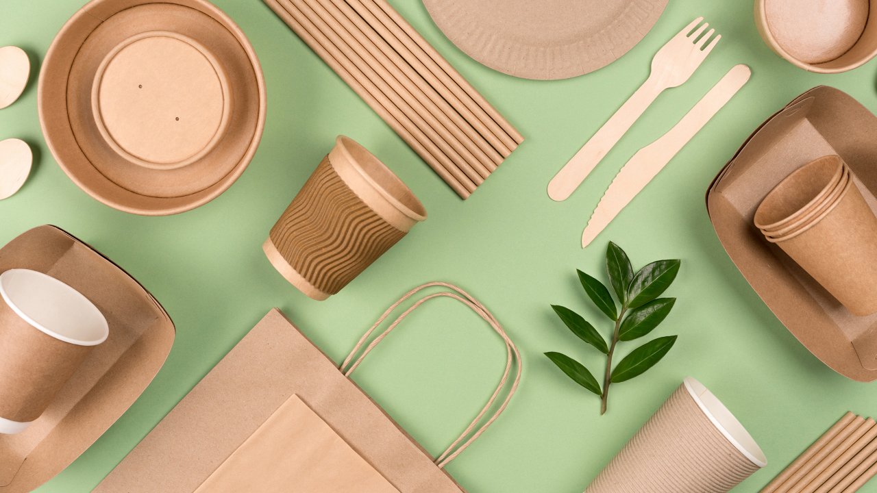 Kraft paper food packaging on light green background.