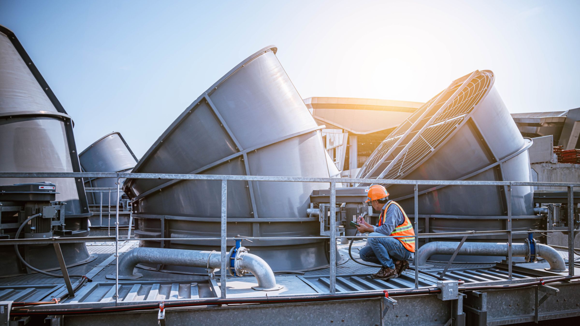 Engineer under checking the industry cooling tower air conditioner is water cooling tower air chiller HVAC of large industrial building to control air system