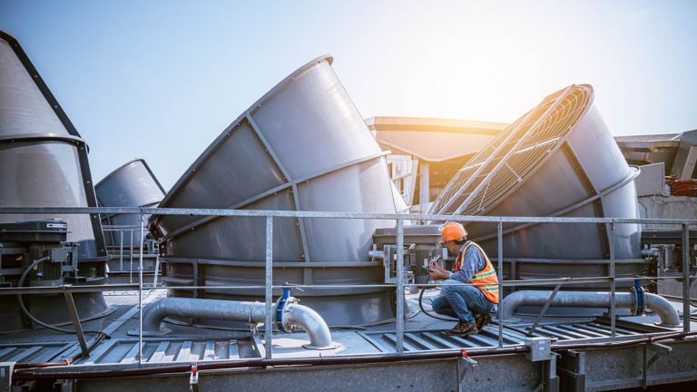 Engineer under checking the industry cooling tower air conditioner is water cooling tower air chiller HVAC of large industrial building to control air system