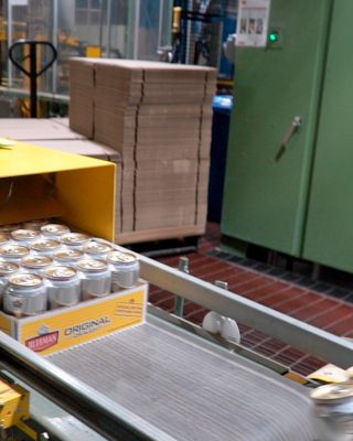 Packaged canned beverages moving along a conveyor