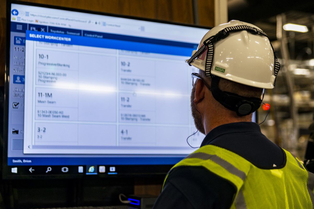 Maintenance worker looking at data