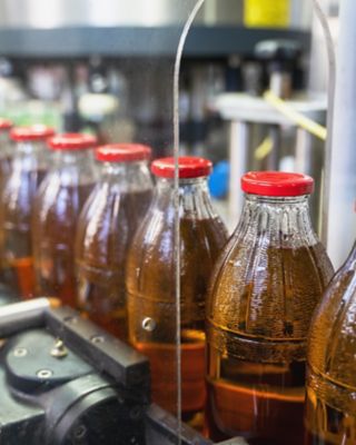 Bottled beverages moving along a conveyor in a beverage plant