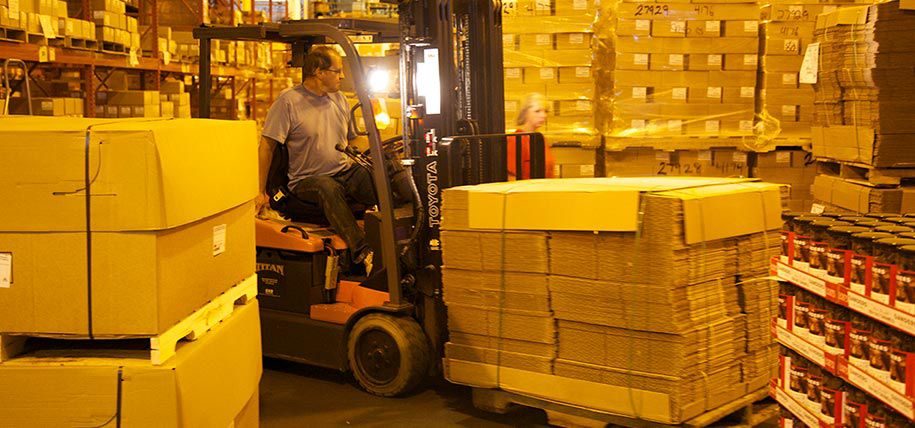 Man moving boxes with a forklift