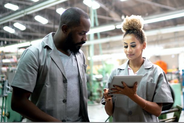 woman showing a man information on her tablet