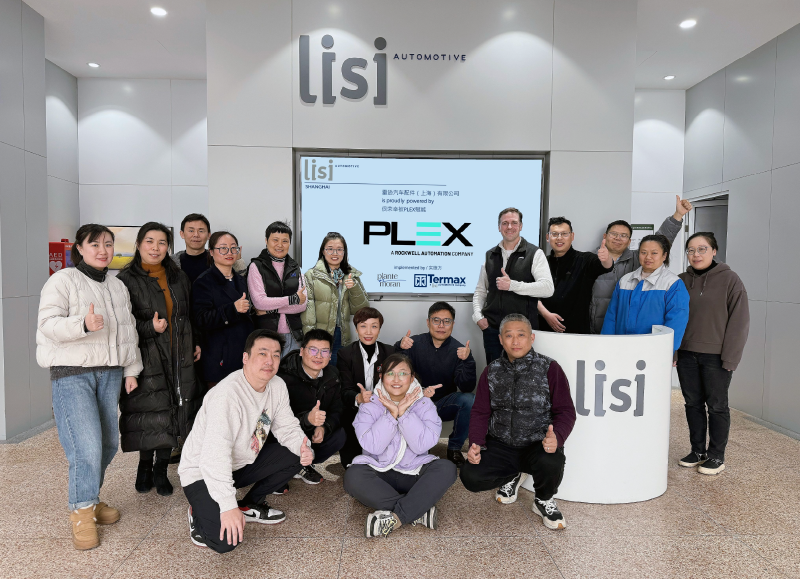 Lisi employees smiling in front of Plex screen